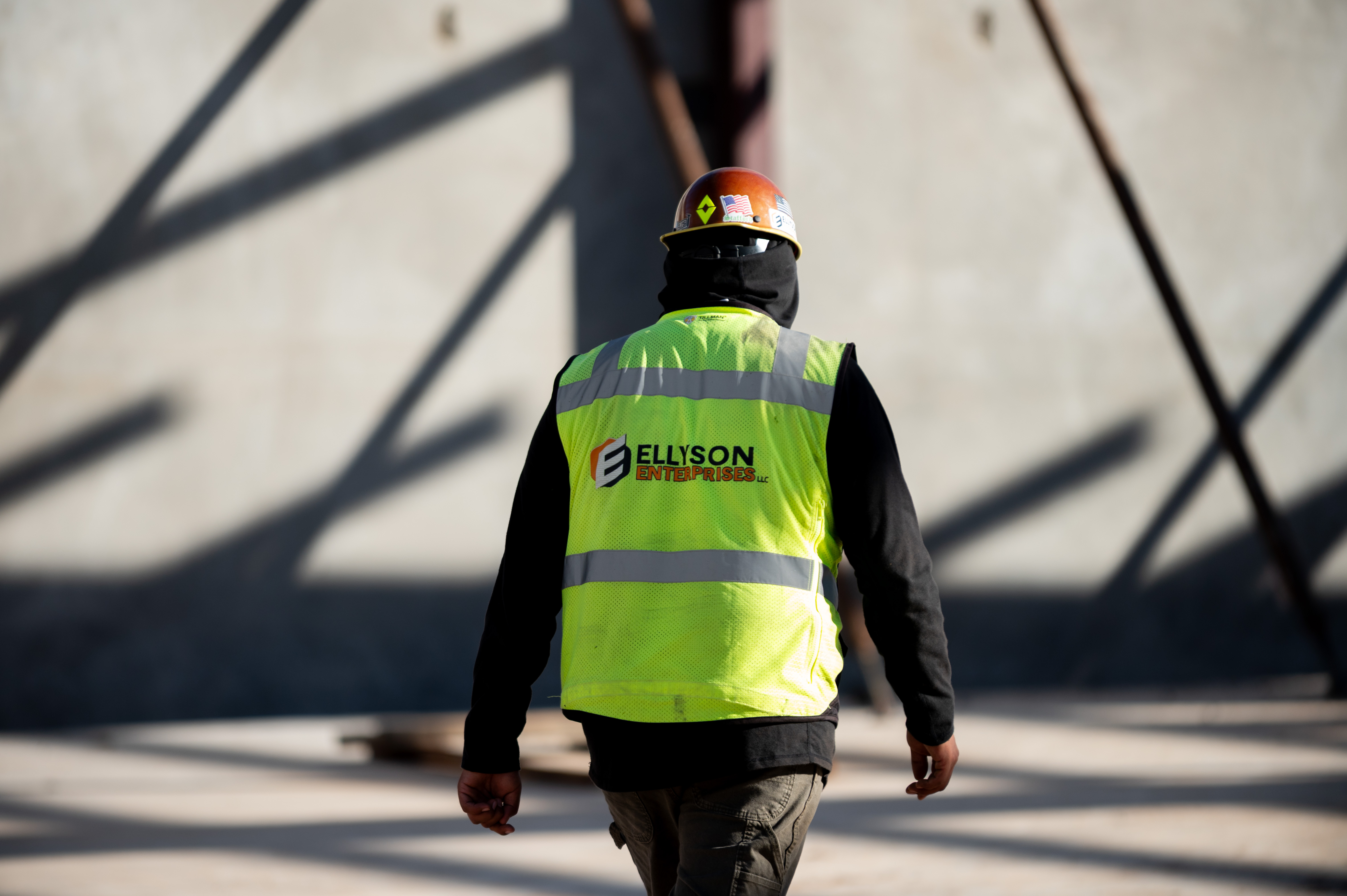 Ellyson crew member in a hi-vis vest walking the jobsite