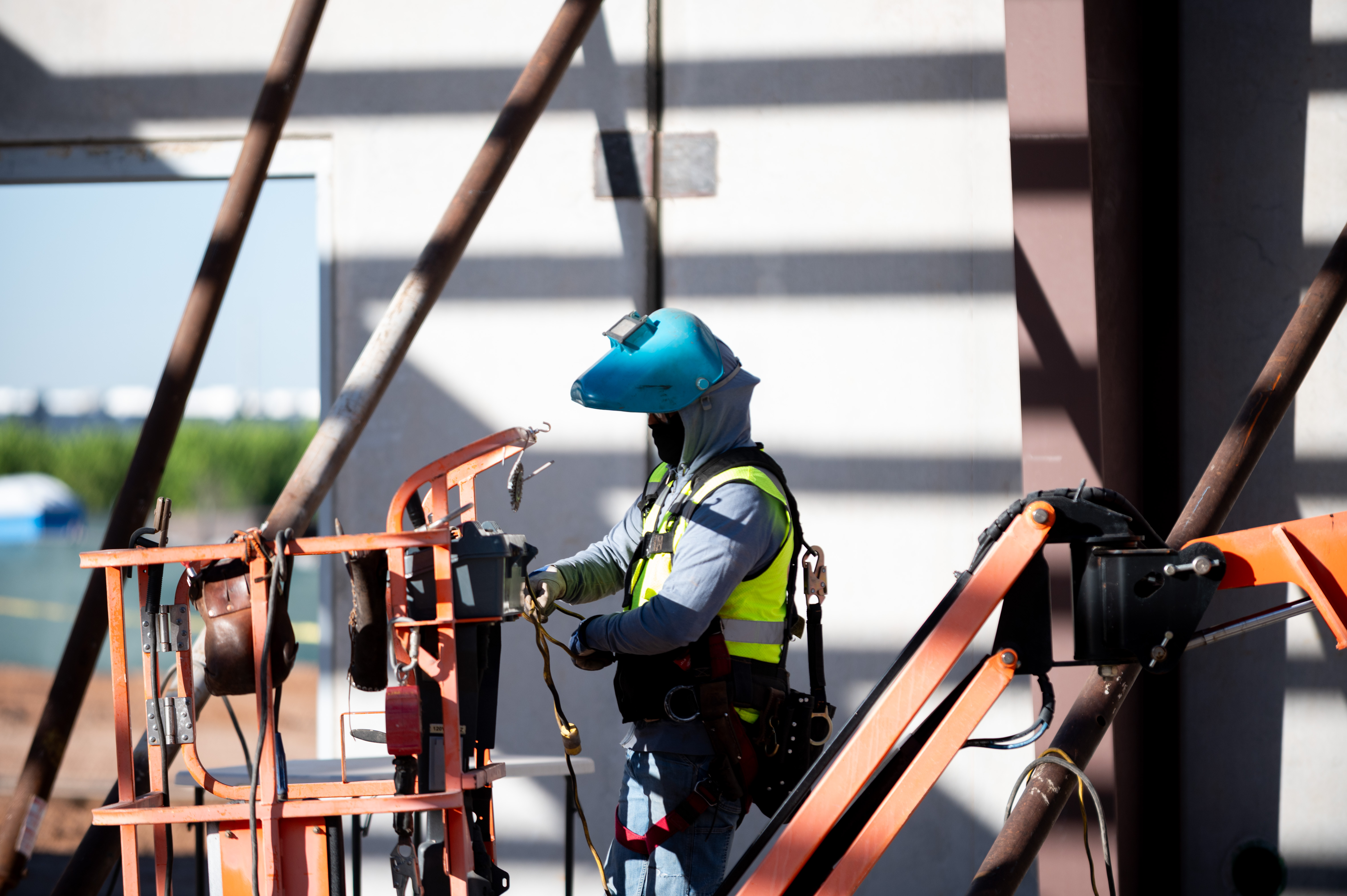 Welder in PPE on a man-lift