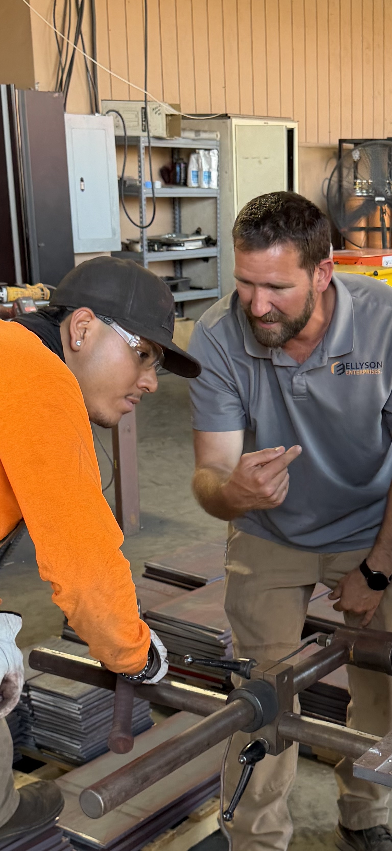 Brad Ellyson walking a crew member through a shop-floor setup